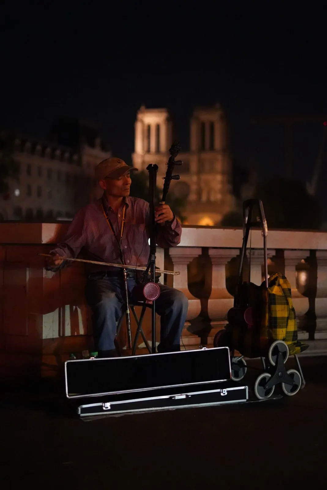 Street musician playing violin in Paris.