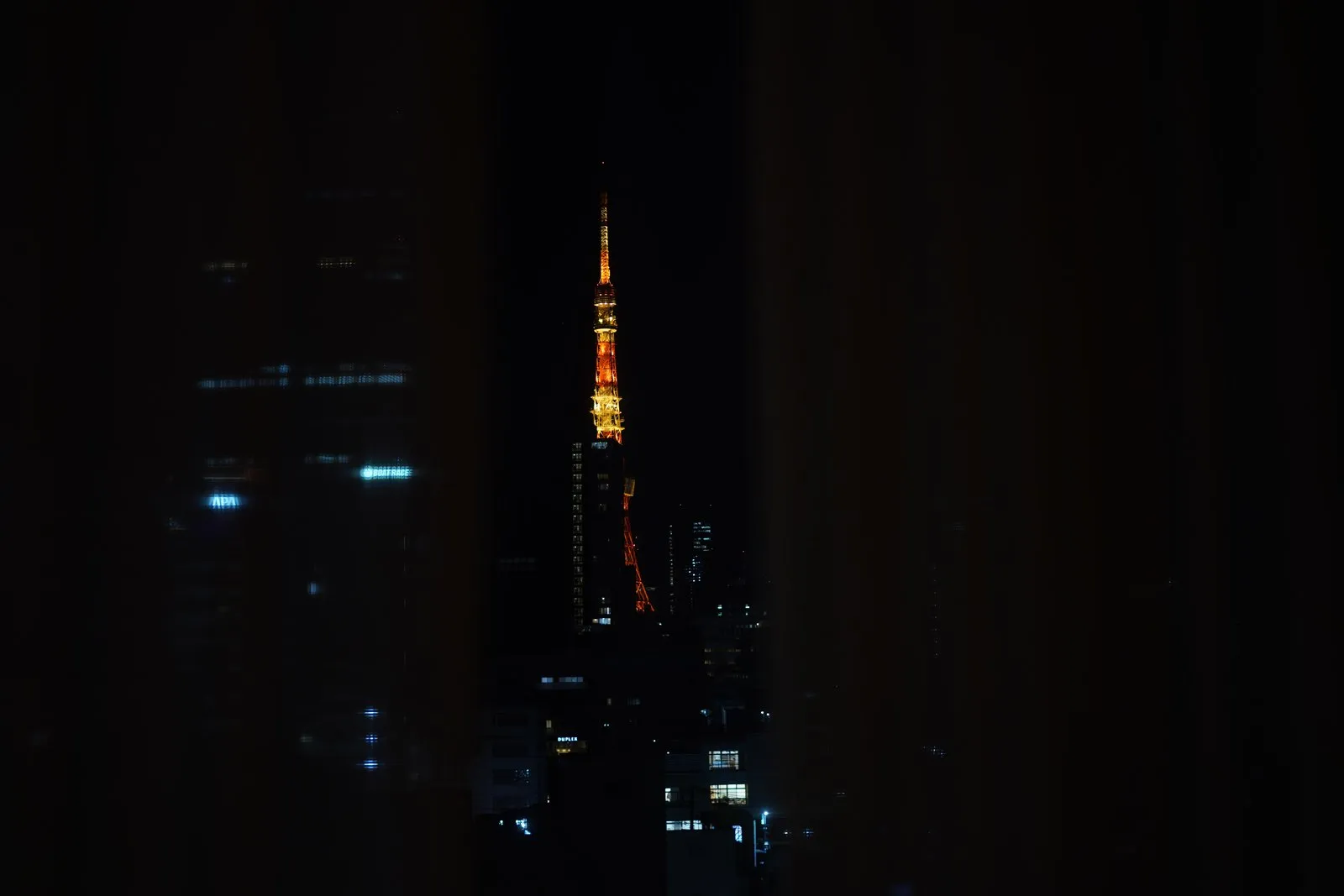 Tokyo Tower at night with city lights.